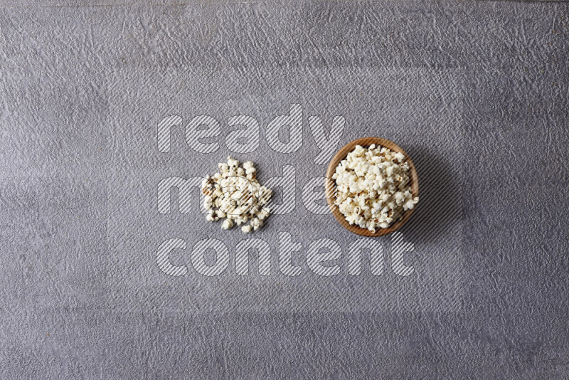Assorted snacks in pottery bowls on grey background