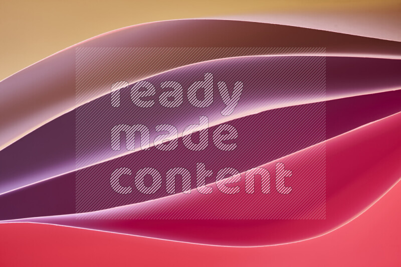 هذه الصورة تعرض تكوين فن الورق التجريدي مع منحنيات ورقية بتدرجات لونية دافئة مختلفة المكونه بواسطة الضوء الملون