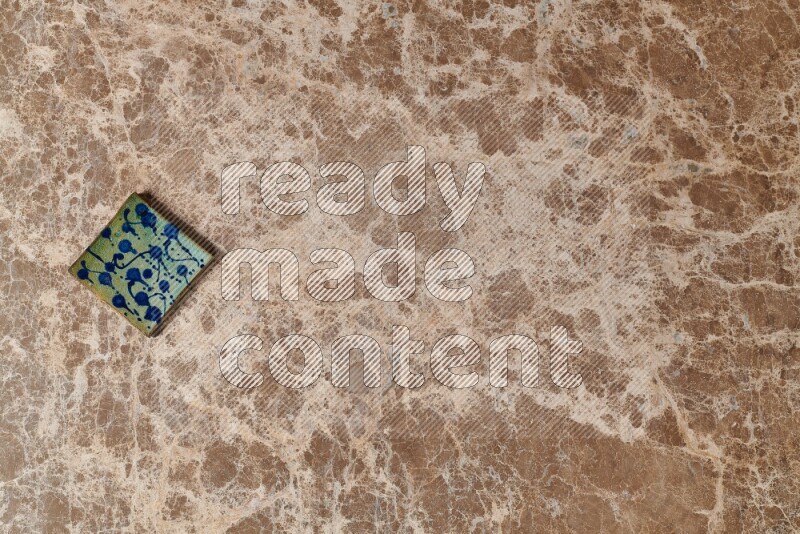 A decorative coaster on beige marble background