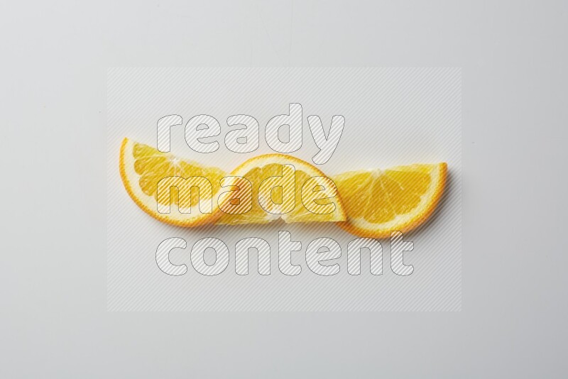 Three halves of an orange slices on white background