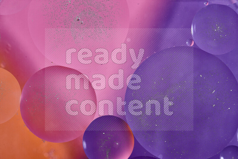 Close-ups of abstract oil bubbles on water surface in shades of purple, orange and pink