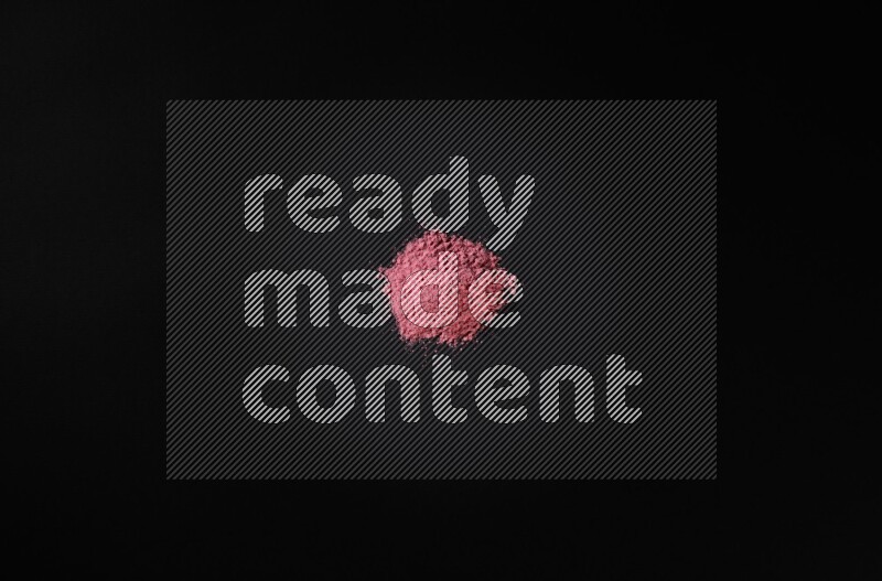 Red powder on black background