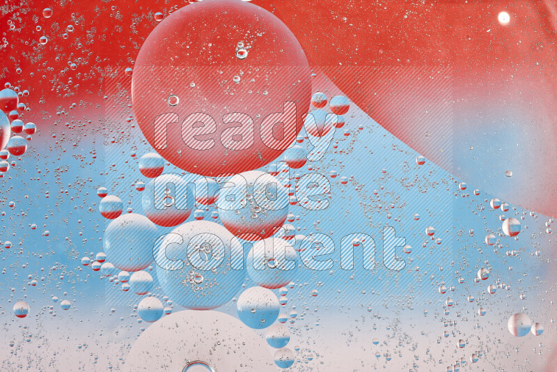 Close-ups of abstract oil bubbles on water surface in shades of red, white and blue
