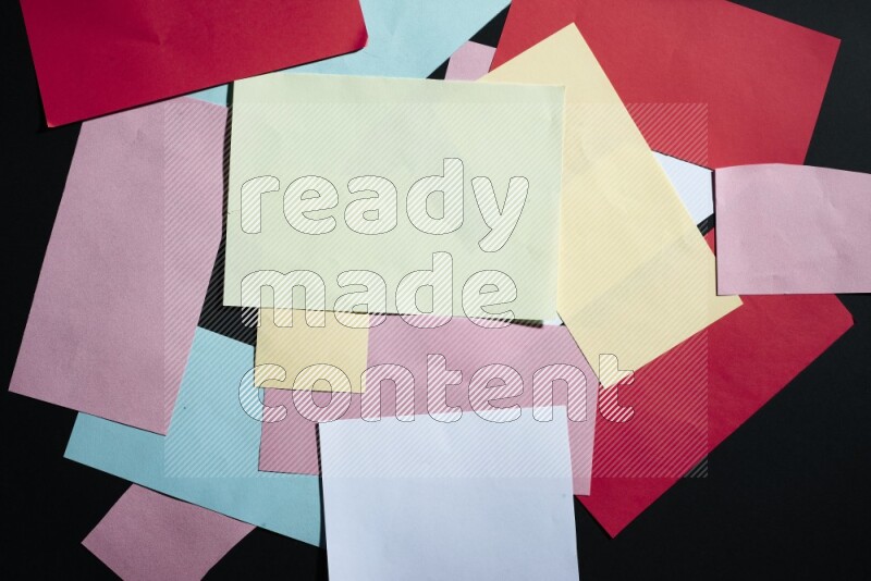 Multicolored paper sheet on black background