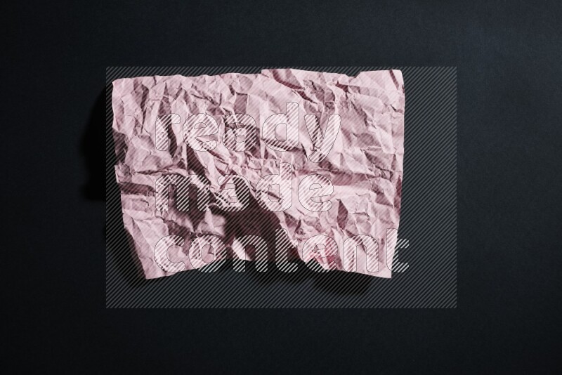 Pink paper sheet on black background