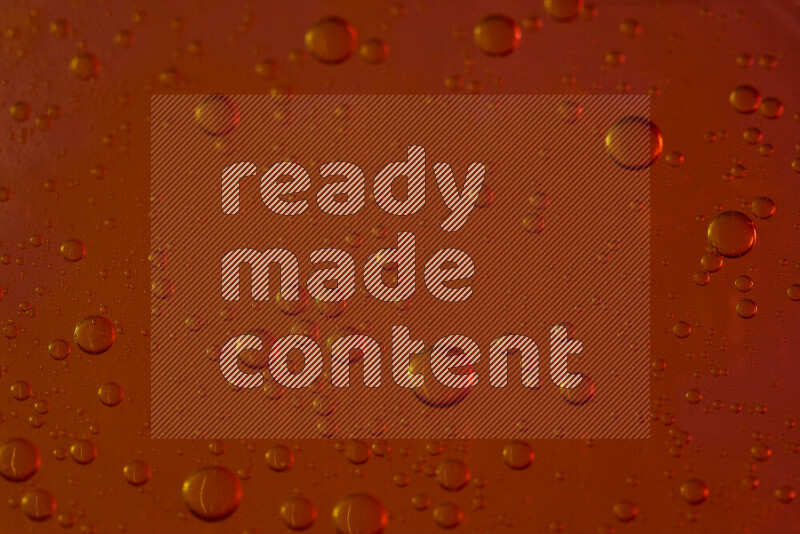 Close-ups of abstract water drops on oil Surface on red background