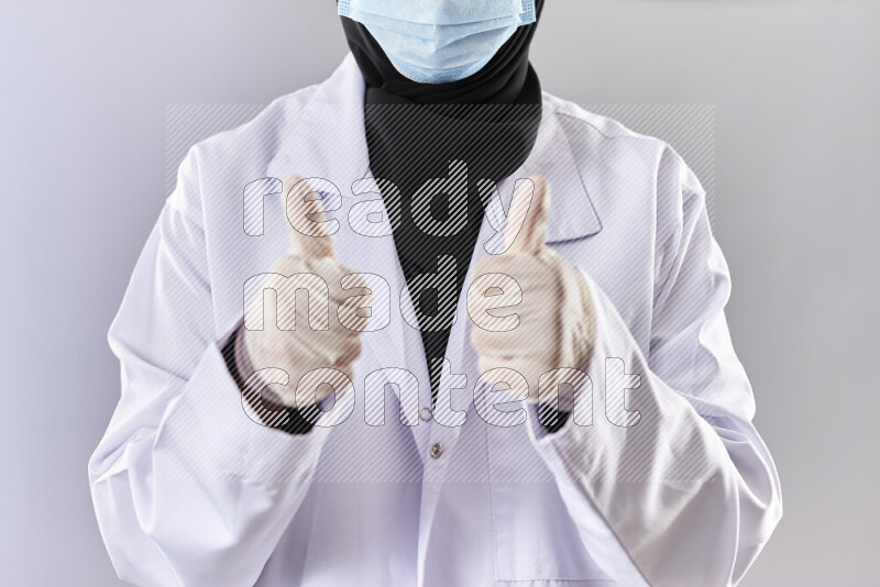 Female doctor wearing an abaya and medical attire in different positions