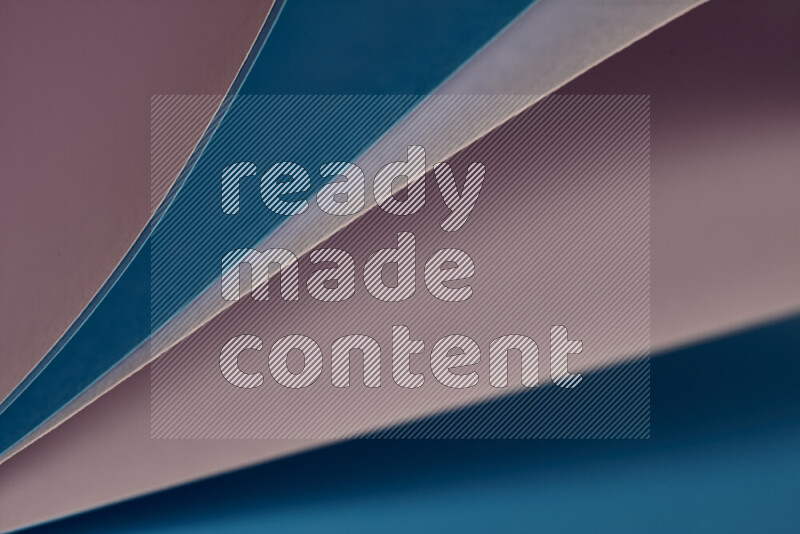 An abstract art showing purple and blue paper sheets arranged in an overlapping curves