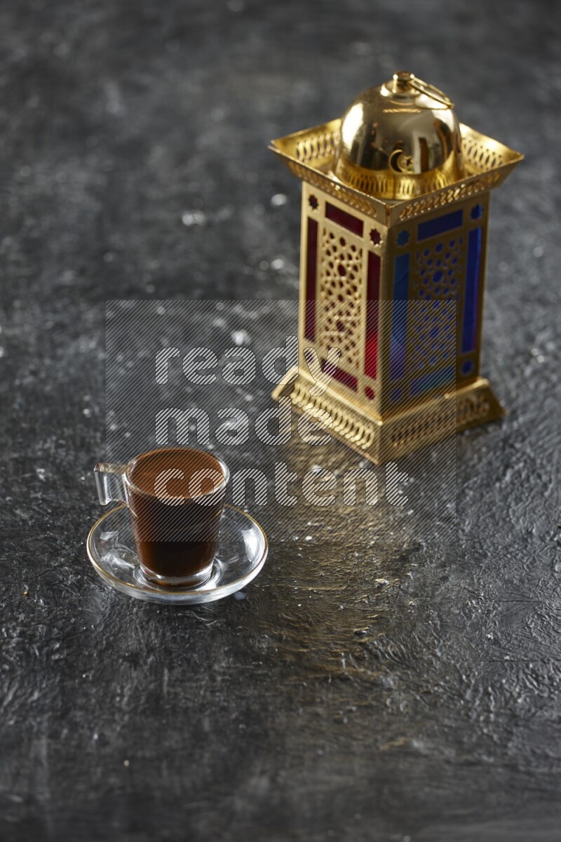 A golden lantern with different drinks, dates, nuts, prayer beads and quran on textured black background
