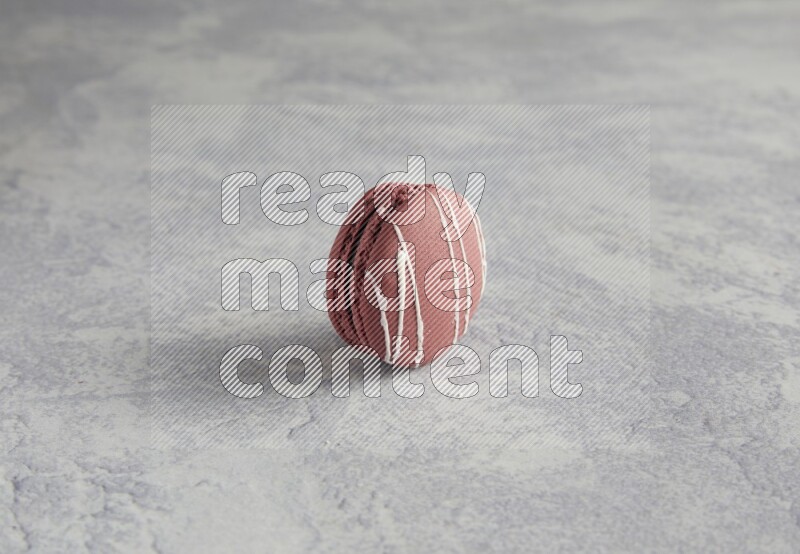 45º Shot of Red Poppy Flower macaron on white  marble background