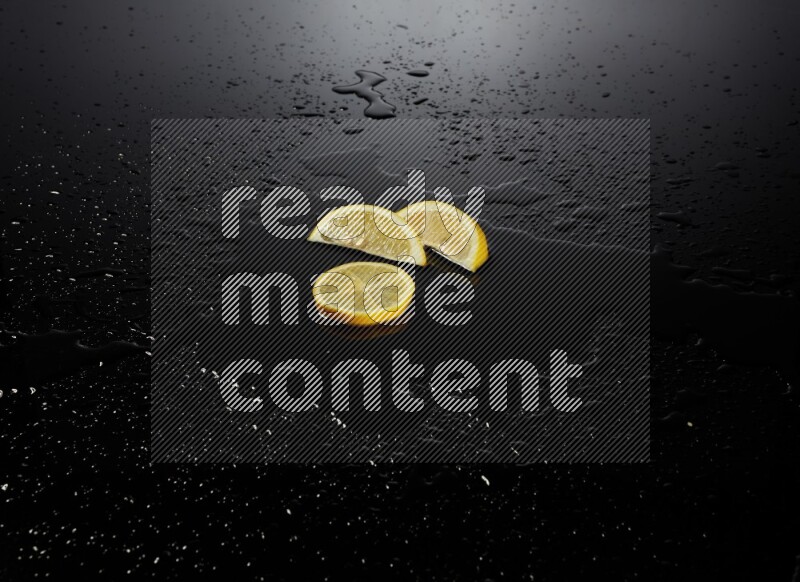 Lemon slices with water drops, and droplets on black background