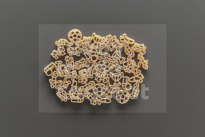 Shaped children pasta on grey background