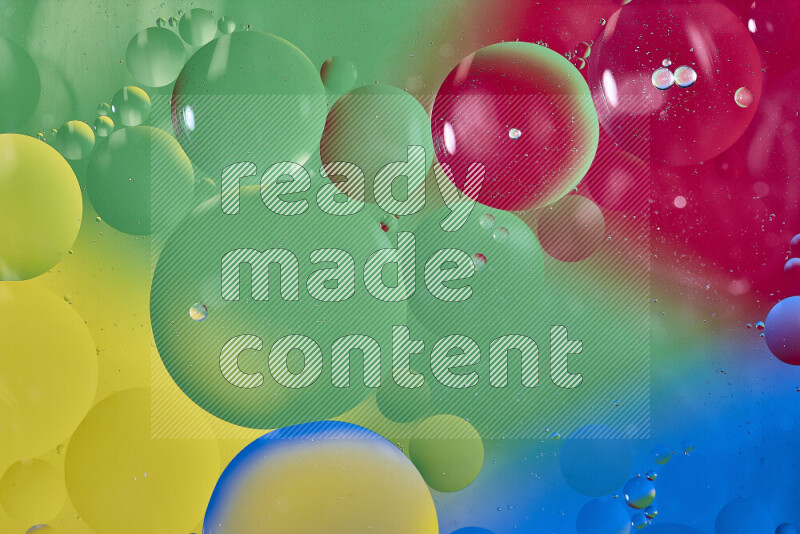 Close-ups of abstract oil bubbles on water surface in shades of yellow, blue, red and green