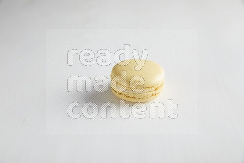 45º Shot of Yellow Vanilla macaron on white background