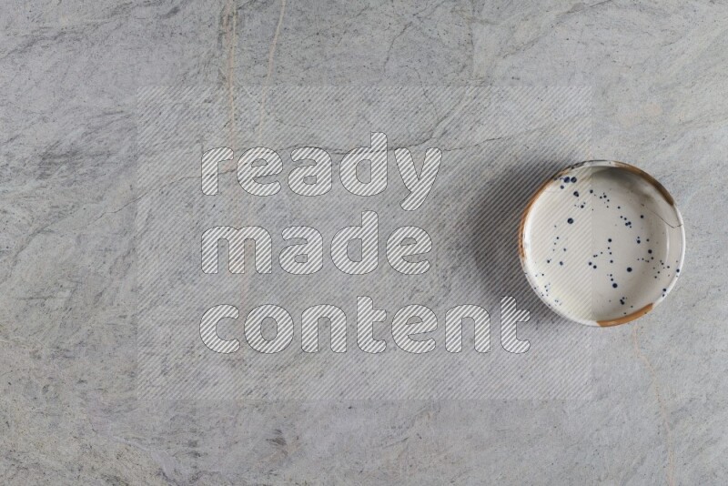 A multicolored pottery Bowl on grey marble background