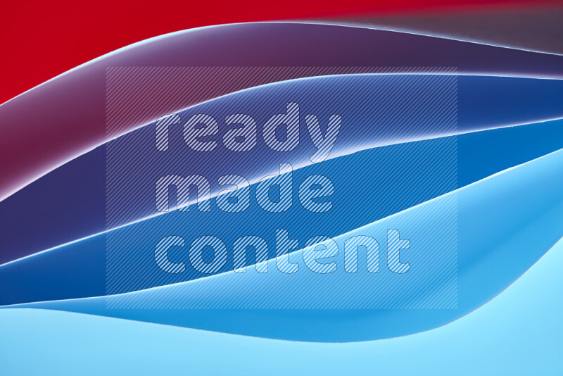 This image showcases an abstract paper art composition with paper curves in blue and red gradients created by colored light