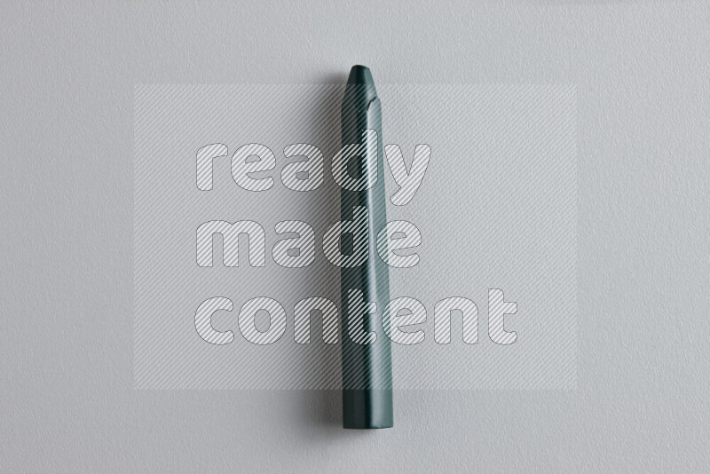 A close-up showing a single wax crayon on grey background