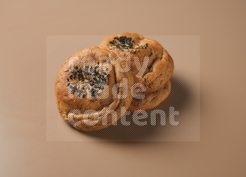 Hasawi cookies field with date and decorated by black seed and Anise grain on a brown background