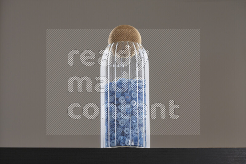 Buttons in a glass jar on black background