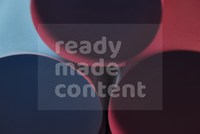 The image shows an abstract paper art with circular shapes in varying shades of blue and red
