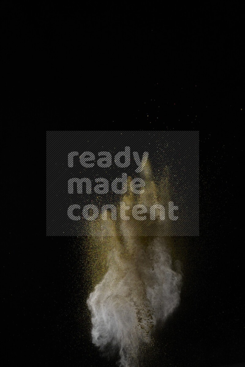 A side view of brown powder explosion on black background