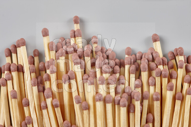 A close-up of a bundle of matches on grey background