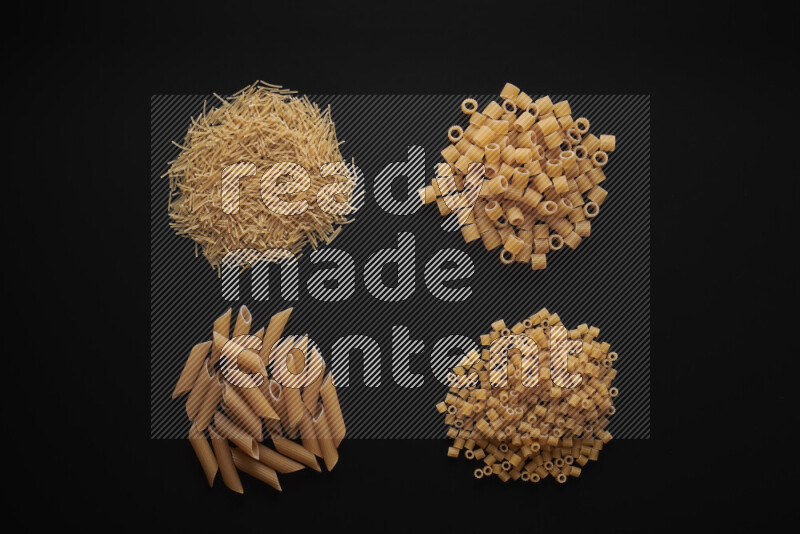 Different pasta types in bunches on black background