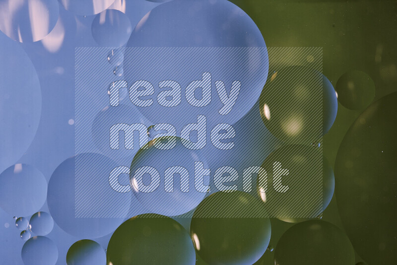 Close-ups of abstract oil bubbles on water surface in shades of blue and green