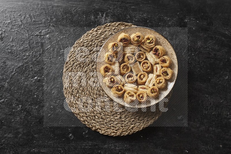 Oriental sweets in pottery plates in a dark setup