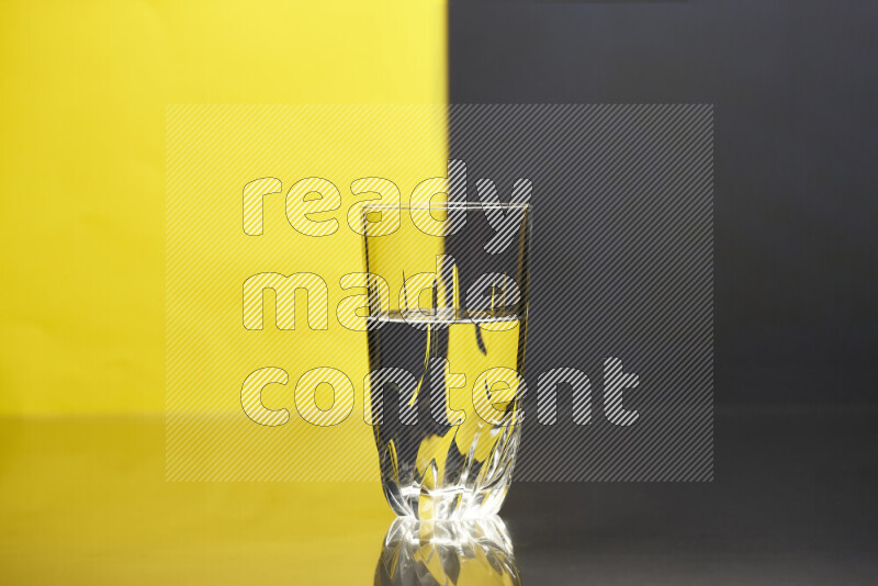 The image features a clear glassware filled with water, set against yellow and black background