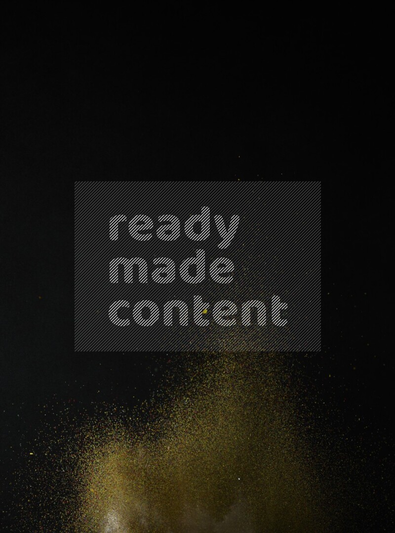 A side view of brown powder explosion on black background