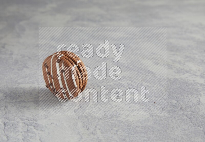 45º Shot of Brown white Chocolate Caramel macaron on white  marble background