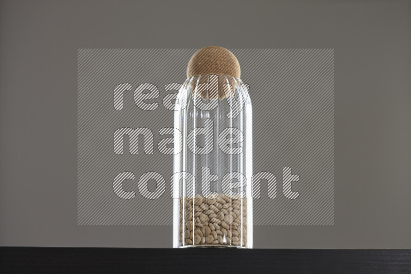 Lupin Beans in a glass jar on black background