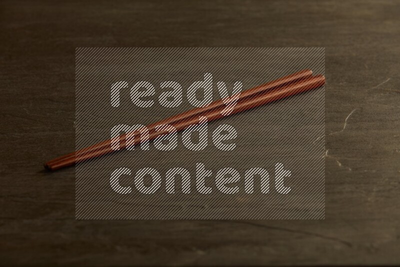 wooden chopsticks on black slate background