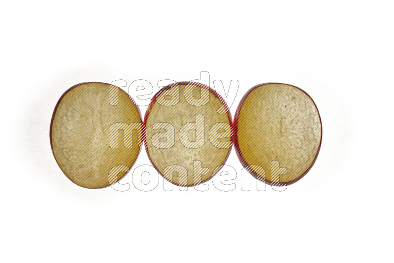Plum slices on illuminated white background