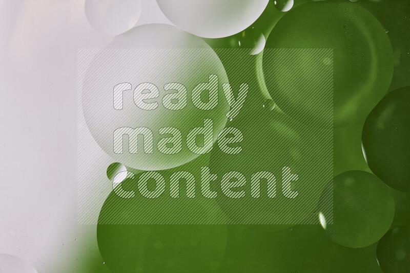 Close-ups of abstract oil bubbles on water surface in shades of white and green