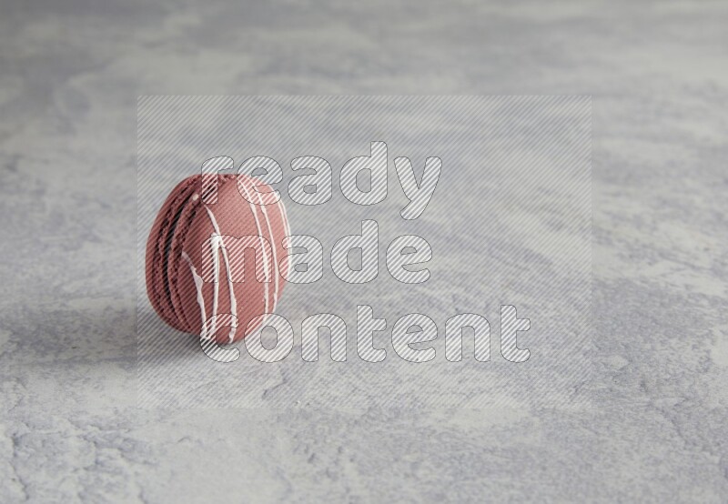 45º Shot of Red Poppy Flower macaron on white  marble background