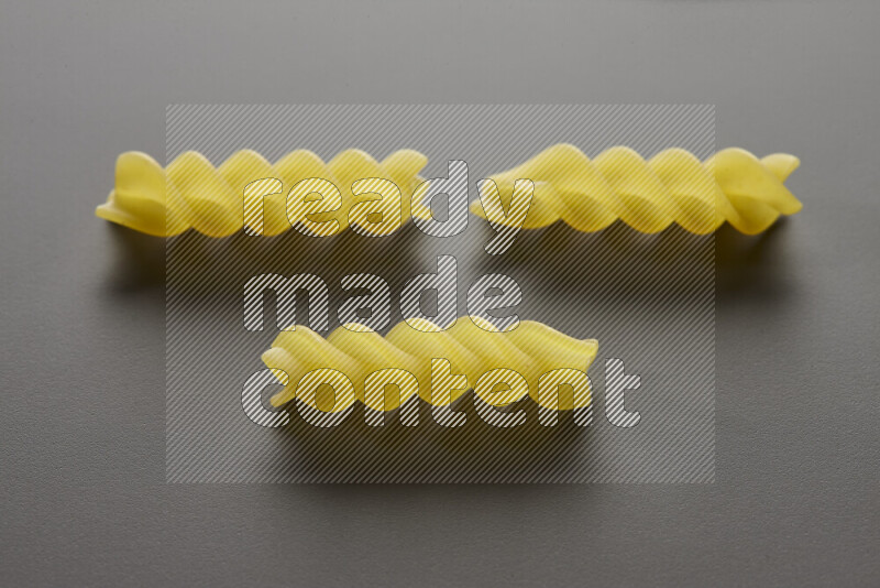 Fusilli pasta on grey background