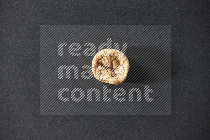 A dried fig on a black background in different angles