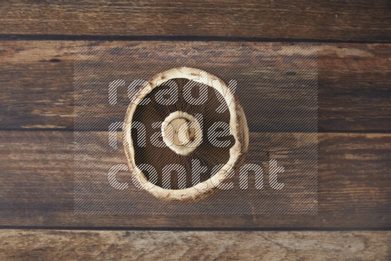 Fresh portobello mushroom topview on a wooden textured background