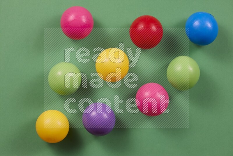 Multicolored plastic balls on different colored backgrounds (kids toys)