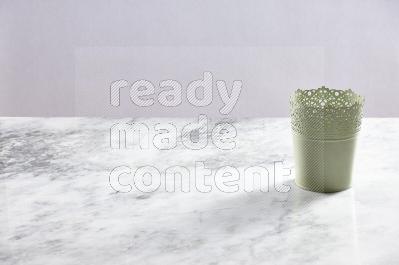 An empty green plant pot on grey marble background