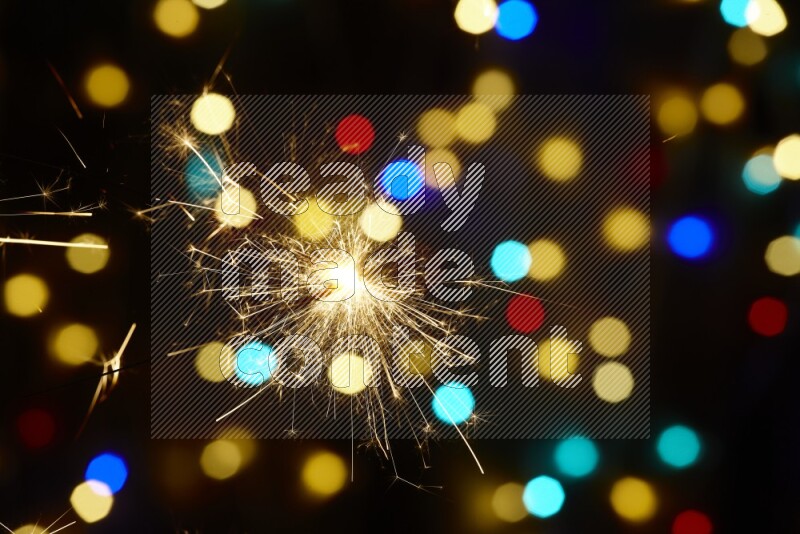 Sparkler candles with multicolored light bokeh background