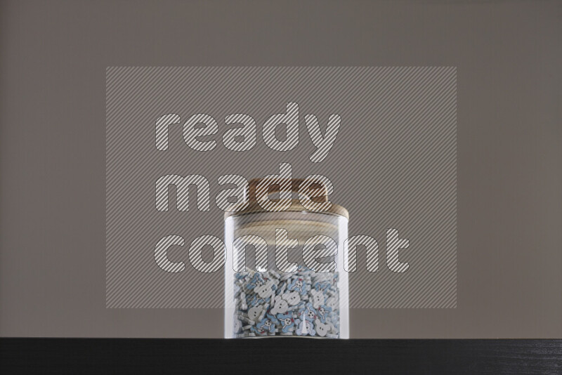Buttons in a glass jar on black background