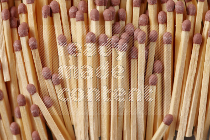 A close-up of a bundle of matches on grey background