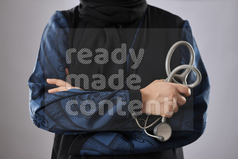 Female doctor wearing an abaya and medical attire in different positions