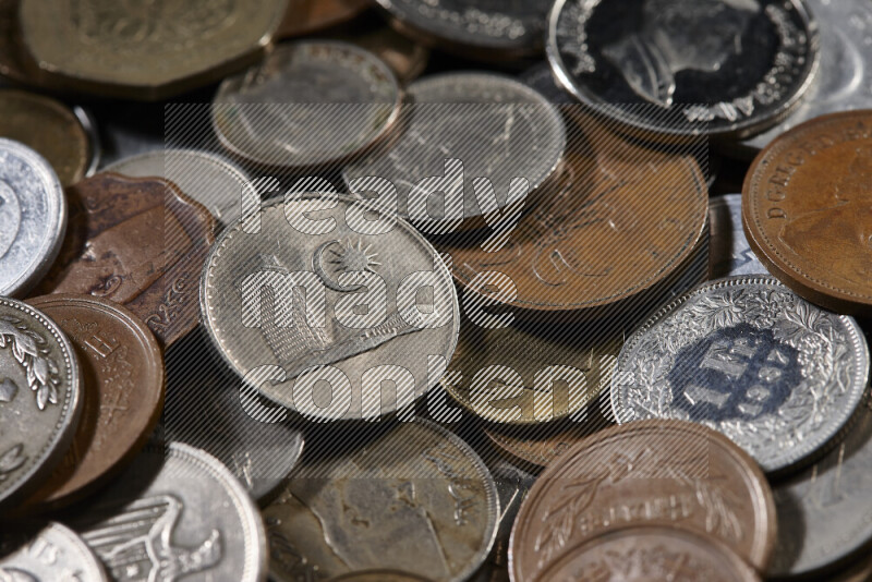 A close-ups of random old coins on black background