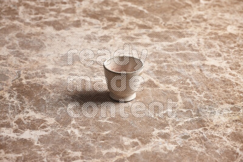 Pottery Cup on Beige Marble Flooring