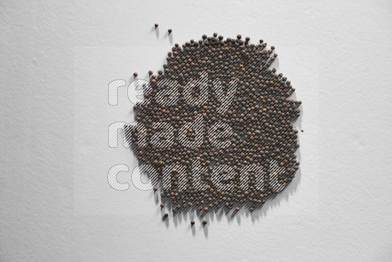 Black pepper on a white flooring