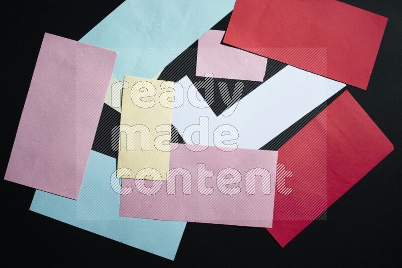 Multicolored paper sheet on black background